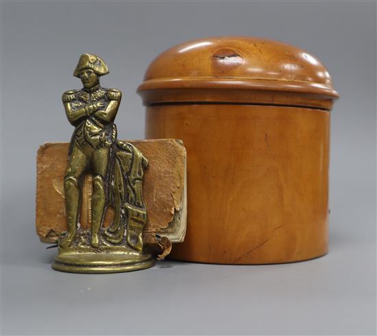 A small brass menu holder modelled as Napoleon and a miniature book, Napoleons Book of Fate and a treen box
